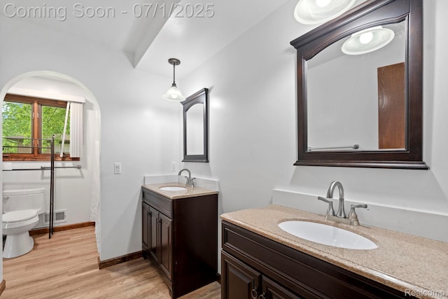 945 E Gunn Rd, Rochester, MI 48306 - bathroom with two vanities and wood finished floors