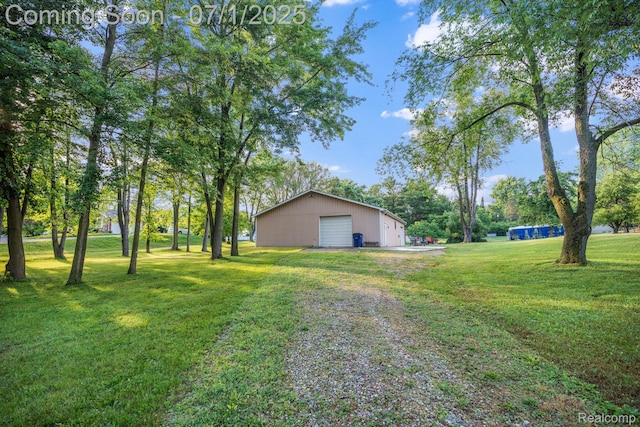 945 E Gunn Rd, Rochester, MI 48306 - view of green lawn featuring a garage, an outbuilding, and driveway