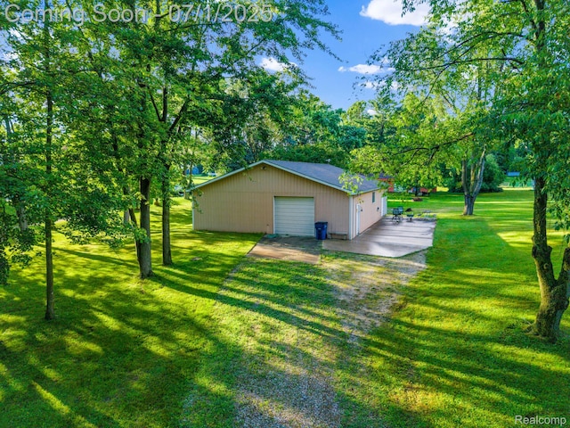 945 E Gunn Rd, Rochester, MI 48306 - view of home's exterior featuring an outbuilding, a detached garage, and a lawn