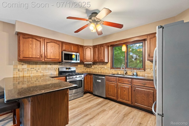 945 E Gunn Rd, Rochester, MI 48306 - kitchen with appliances with stainless steel finishes, a peninsula, brown cabinetry, and tasteful backsplash