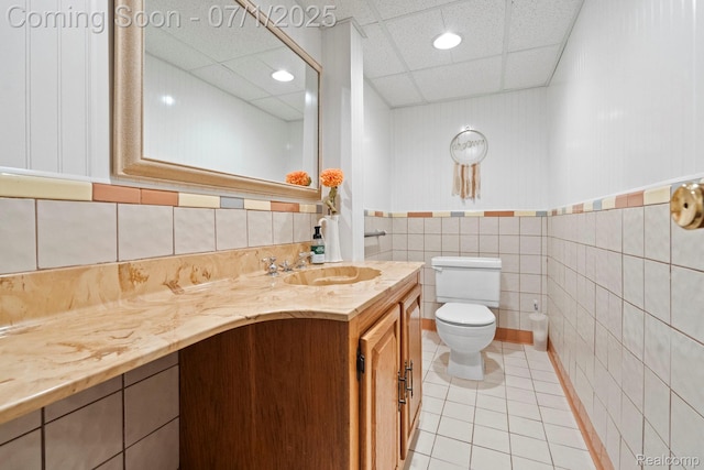 945 E Gunn Rd, Rochester, MI 48306 - bathroom with tile patterned floors, vanity, a drop ceiling, a wainscoted wall, and recessed lighting