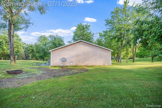 945 E Gunn Rd, Rochester, MI 48306 - view of home's exterior with a lawn, a pole building, and an outbuilding