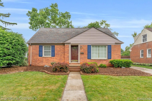 1717 Penistone St, Birmingham, MI 48009 - view of front of house with brick siding, a front yard, and a shingled roof