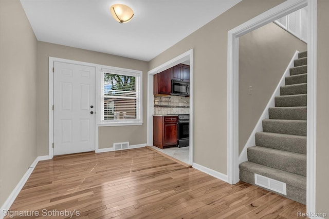 1717 Penistone St, Birmingham, MI 48009 - foyer with light wood-type flooring and stairway