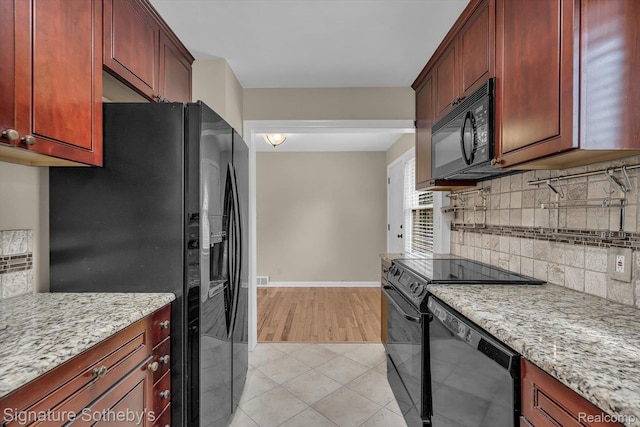 1717 Penistone St, Birmingham, MI 48009 - kitchen featuring black appliances, decorative backsplash, reddish brown cabinets, light stone countertops, and light tile patterned floors