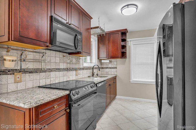1717 Penistone St, Birmingham, MI 48009 - kitchen with black appliances, tasteful backsplash, and light stone countertops