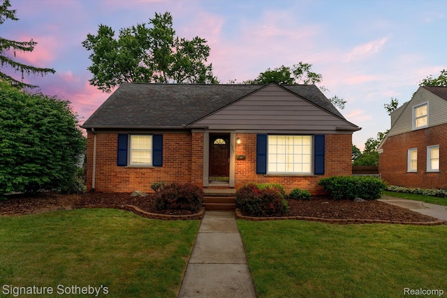 1717 Penistone St, Birmingham, MI 48009 - view of front of house with brick siding, a front lawn, and roof with shingles