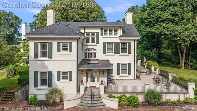 777 Kensington Ln, Bloomfield Hills, MI 48304 - view of front of home featuring a chimney, a patio, and stucco siding