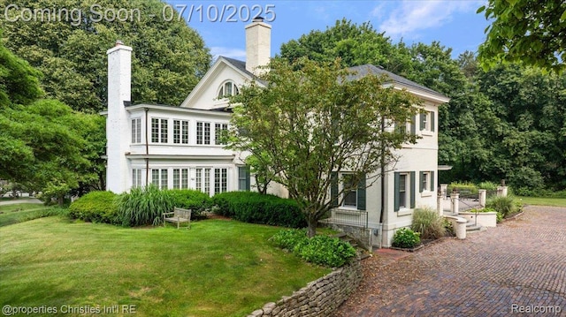 777 Kensington Ln, Bloomfield Hills, MI 48304 - back of property with a lawn and a chimney