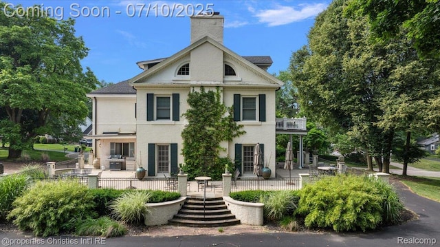 777 Kensington Ln, Bloomfield Hills, MI 48304 - view of front of home featuring a patio area, a balcony, a chimney, and stucco siding