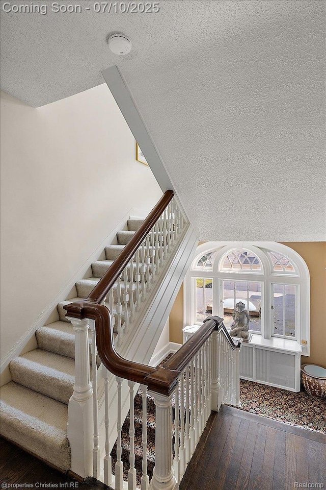 777 Kensington Ln, Bloomfield Hills, MI 48304 - stairway featuring a textured ceiling and hardwood / wood-style flooring