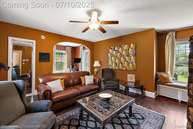 777 Kensington Ln, Bloomfield Hills, MI 48304 - living room featuring arched walkways, a ceiling fan, wood finished floors, and radiator heating unit