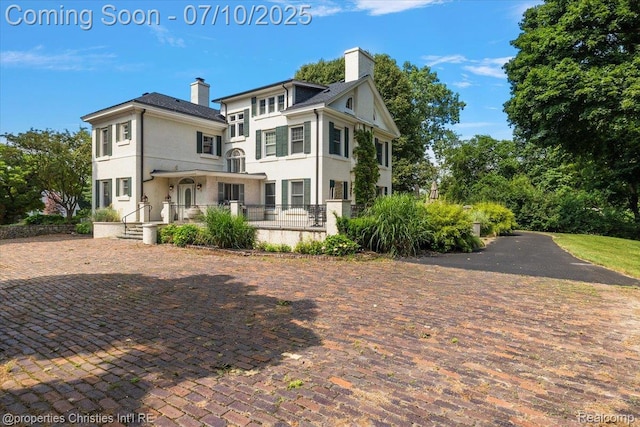 777 Kensington Ln, Bloomfield Hills, MI 48304 - view of front facade with a chimney and stucco siding