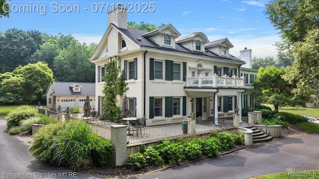 777 Kensington Ln, Bloomfield Hills, MI 48304 - view of front of house with a balcony, a chimney, and stucco siding