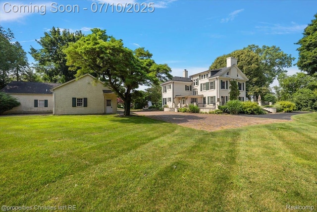 777 Kensington Ln, Bloomfield Hills, MI 48304 - rear view of property with a lawn