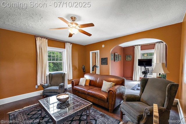 777 Kensington Ln, Bloomfield Hills, MI 48304 - living area with arched walkways, a ceiling fan, and a textured ceiling