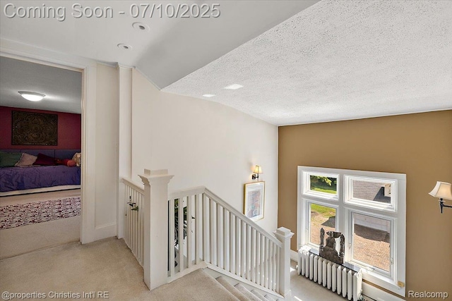 777 Kensington Ln, Bloomfield Hills, MI 48304 - hall with an upstairs landing, carpet, and a textured ceiling