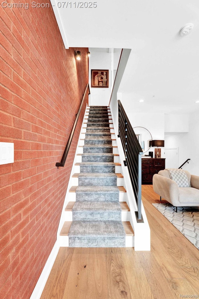 258 Edmund Pl, Detroit, MI 48201 - stairway with wood finished floors and brick wall