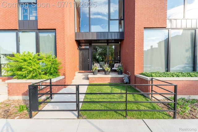 258 Edmund Pl, Detroit, MI 48201 - view of exterior entry featuring brick siding and a gate