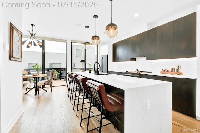 258 Edmund Pl, Detroit, MI 48201 - kitchen with modern cabinets, light countertops, decorative backsplash, light wood-style flooring, and recessed lighting