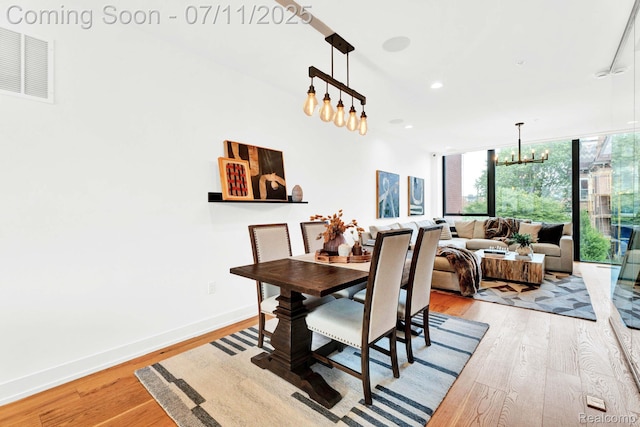 258 Edmund Pl, Detroit, MI 48201 - dining room featuring a chandelier, light wood-style flooring, and recessed lighting