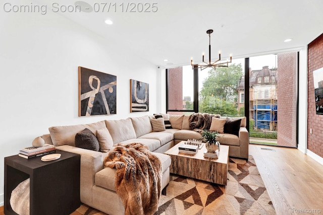 258 Edmund Pl, Detroit, MI 48201 - living room featuring light wood-type flooring, recessed lighting, a chandelier, and floor to ceiling windows
