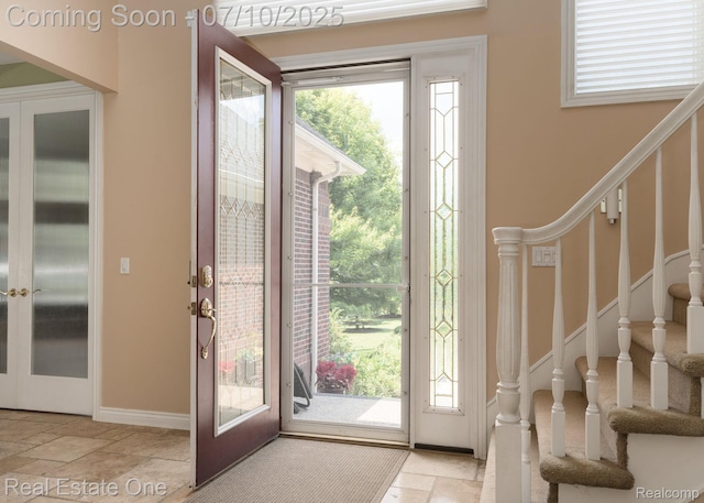 6120 Evanswood Rd, Troy, MI 48085 - entryway featuring stone tile floors, stairway, and french doors