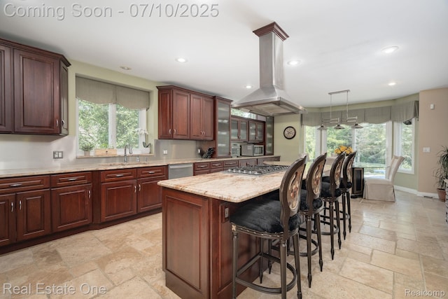 6120 Evanswood Rd, Troy, MI 48085 - kitchen featuring island exhaust hood, stone tile flooring, appliances with stainless steel finishes, recessed lighting, and healthy amount of natural light