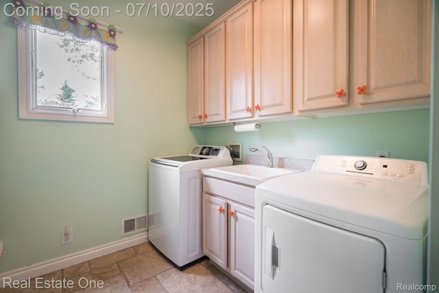 6120 Evanswood Rd, Troy, MI 48085 - laundry area featuring cabinet space, washer and clothes dryer, and stone tile flooring