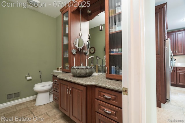6120 Evanswood Rd, Troy, MI 48085 - bathroom with vanity and stone tile flooring