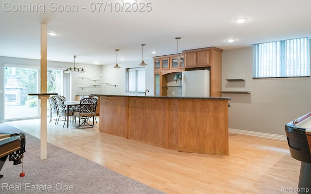 6120 Evanswood Rd, Troy, MI 48085 - kitchen featuring freestanding refrigerator, healthy amount of natural light, recessed lighting, light wood finished floors, and glass insert cabinets