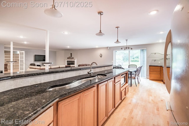 6120 Evanswood Rd, Troy, MI 48085 - kitchen featuring refrigerator, light wood-style flooring, decorative light fixtures, dark stone counters, and recessed lighting