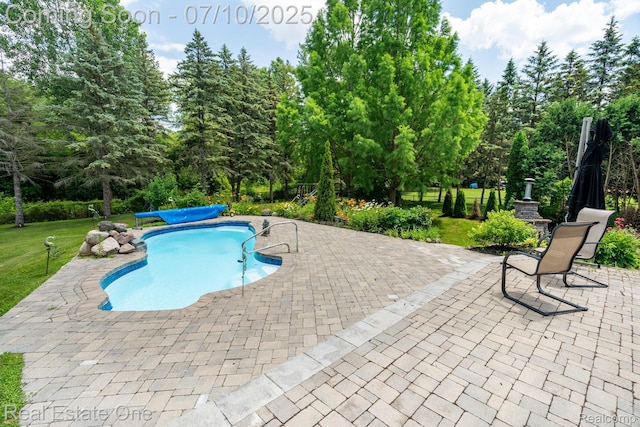 6120 Evanswood Rd, Troy, MI 48085 - swimming pool featuring a patio area, a lawn, and view of wooded area