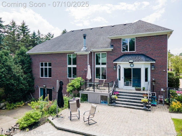 6120 Evanswood Rd, Troy, MI 48085 - rear view of house with a shingled roof, a patio area, and brick siding