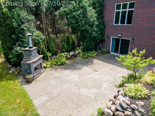 6120 Evanswood Rd, Troy, MI 48085 - view of patio featuring an outdoor stone fireplace