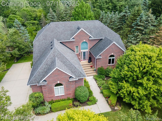 6120 Evanswood Rd, Troy, MI 48085 - view of front of home with brick siding and a shingled roof