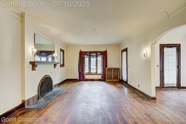 66 Oakdale Blvd, Pleasant Ridge, MI 48069 - unfurnished living room with wood finished floors, arched walkways, and a fireplace