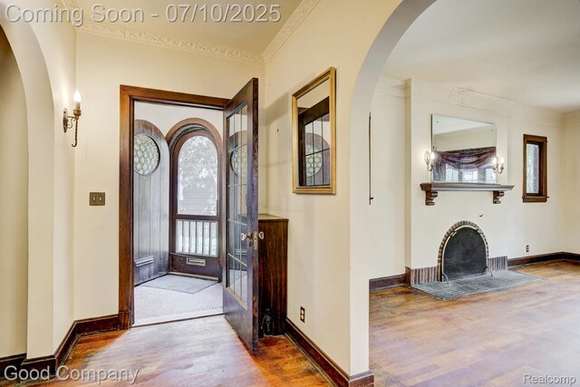 66 Oakdale Blvd, Pleasant Ridge, MI 48069 - entrance foyer with wood finished floors, crown molding, arched walkways, and a fireplace