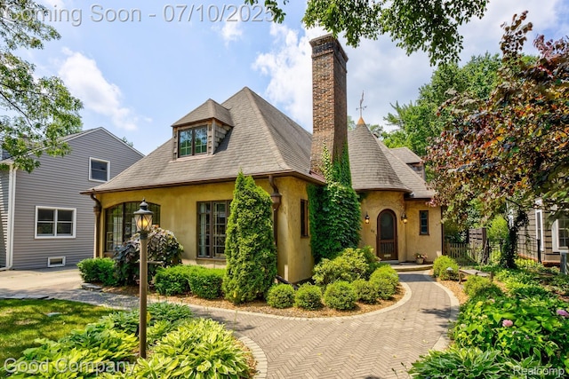 66 Oakdale Blvd, Pleasant Ridge, MI 48069 - view of front facade with stucco siding, a chimney, and a shingled roof