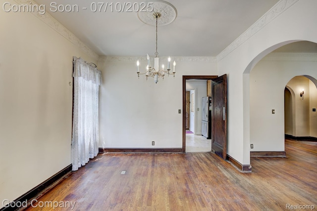 66 Oakdale Blvd, Pleasant Ridge, MI 48069 - unfurnished room featuring a chandelier, wood finished floors, arched walkways, and ornamental molding