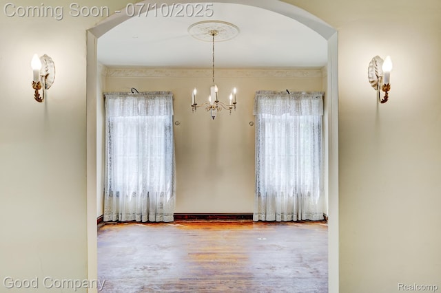 66 Oakdale Blvd, Pleasant Ridge, MI 48069 - unfurnished dining area featuring healthy amount of natural light, arched walkways, a chandelier, and wood finished floors