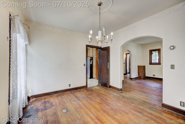 66 Oakdale Blvd, Pleasant Ridge, MI 48069 - empty room with arched walkways, a chandelier, wood finished floors, and crown molding