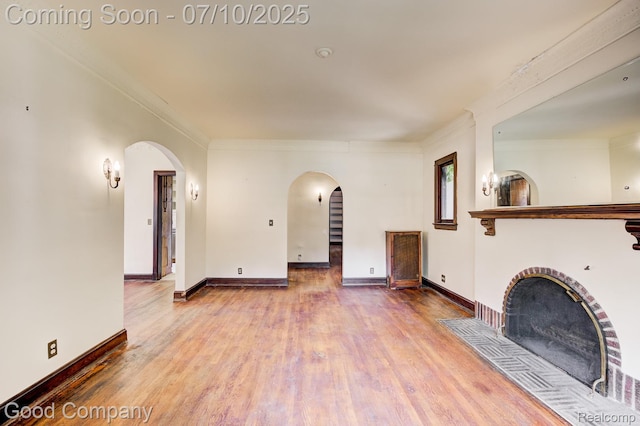 66 Oakdale Blvd, Pleasant Ridge, MI 48069 - unfurnished living room with arched walkways, wood finished floors, and crown molding