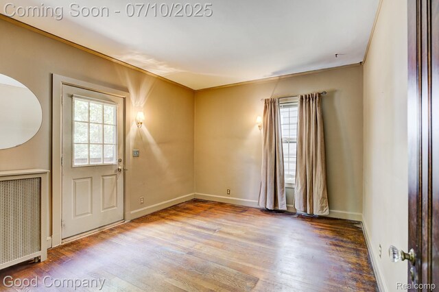66 Oakdale Blvd, Pleasant Ridge, MI 48069 - foyer entrance with healthy amount of natural light, wood finished floors, crown molding, and radiator