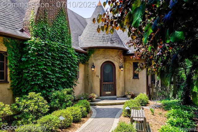 66 Oakdale Blvd, Pleasant Ridge, MI 48069 - doorway to property featuring a high end roof, stucco siding, and a chimney