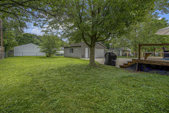 646 Dellwood Dr, Ann Arbor, MI 48103 - view of yard with an outbuilding, a detached garage, and a wooden deck