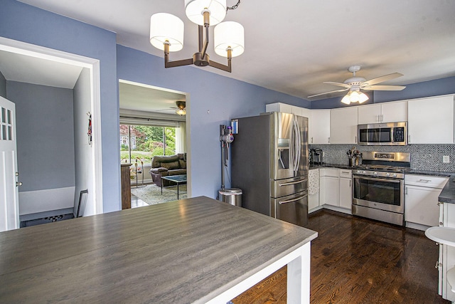 646 Dellwood Dr, Ann Arbor, MI 48103 - kitchen with appliances with stainless steel finishes, ceiling fan, dark countertops, white cabinets, and tasteful backsplash