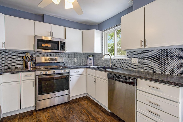 646 Dellwood Dr, Ann Arbor, MI 48103 - kitchen featuring appliances with stainless steel finishes, dark countertops, a ceiling fan, and white cabinets