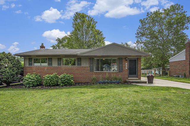 646 Dellwood Dr, Ann Arbor, MI 48103 - view of front facade with brick siding, a front lawn, and a chimney