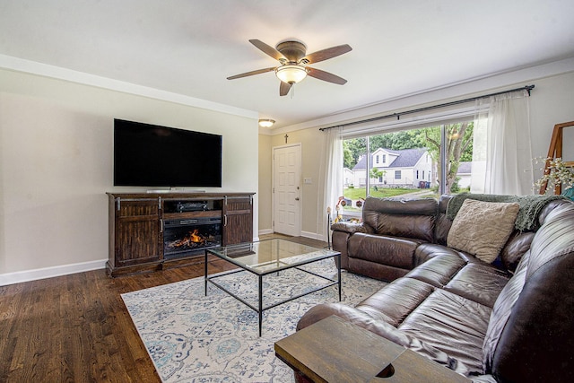 646 Dellwood Dr, Ann Arbor, MI 48103 - living area featuring a ceiling fan, wood finished floors, a warm lit fireplace, and crown molding
